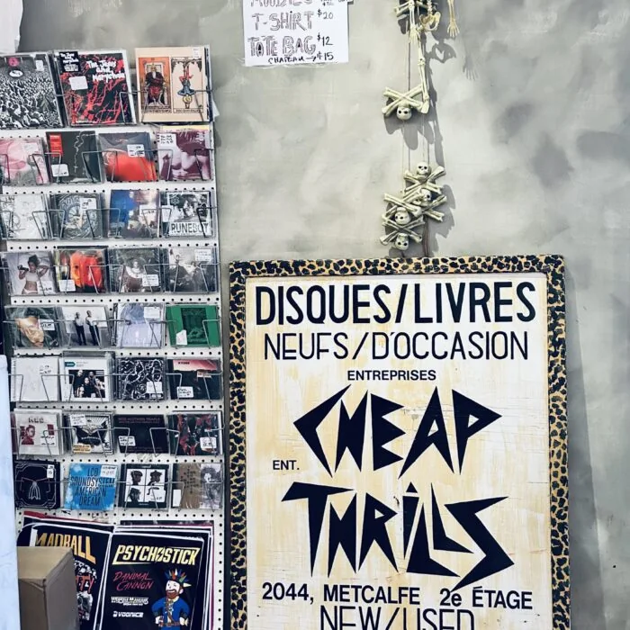 Bilingual Disques/Livres sign with the Cheap Thrills logo next to a CD rack