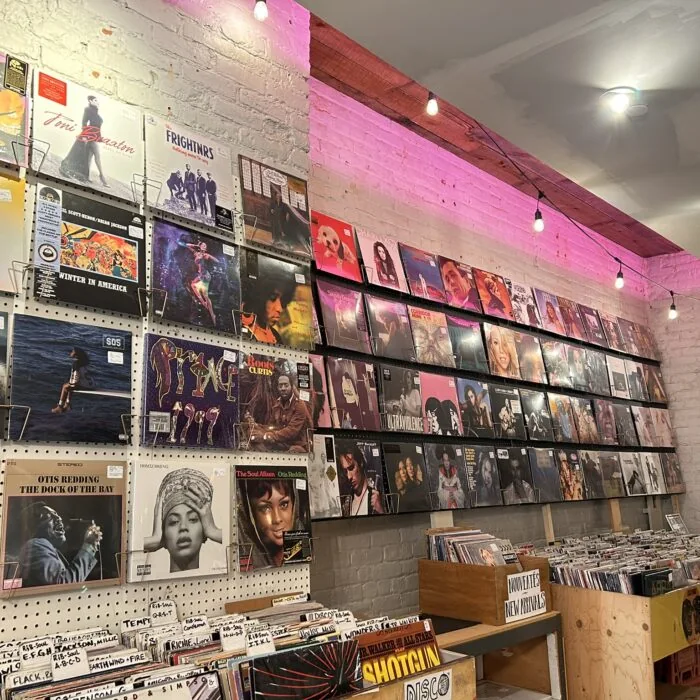 Soul wall and pink-lit shelves of records